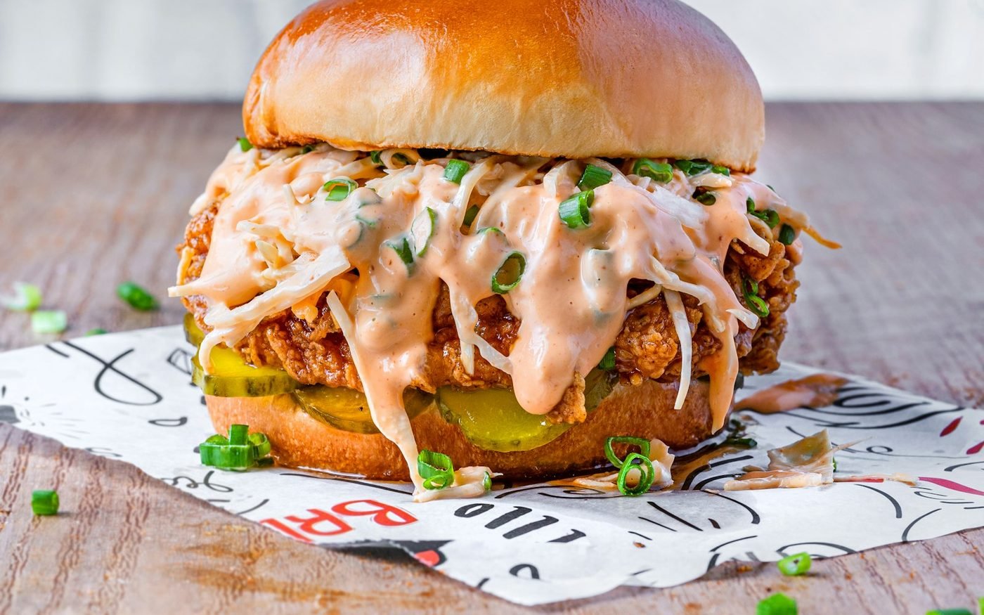 Crispy chicken burger topped with creamy slaw and pickles